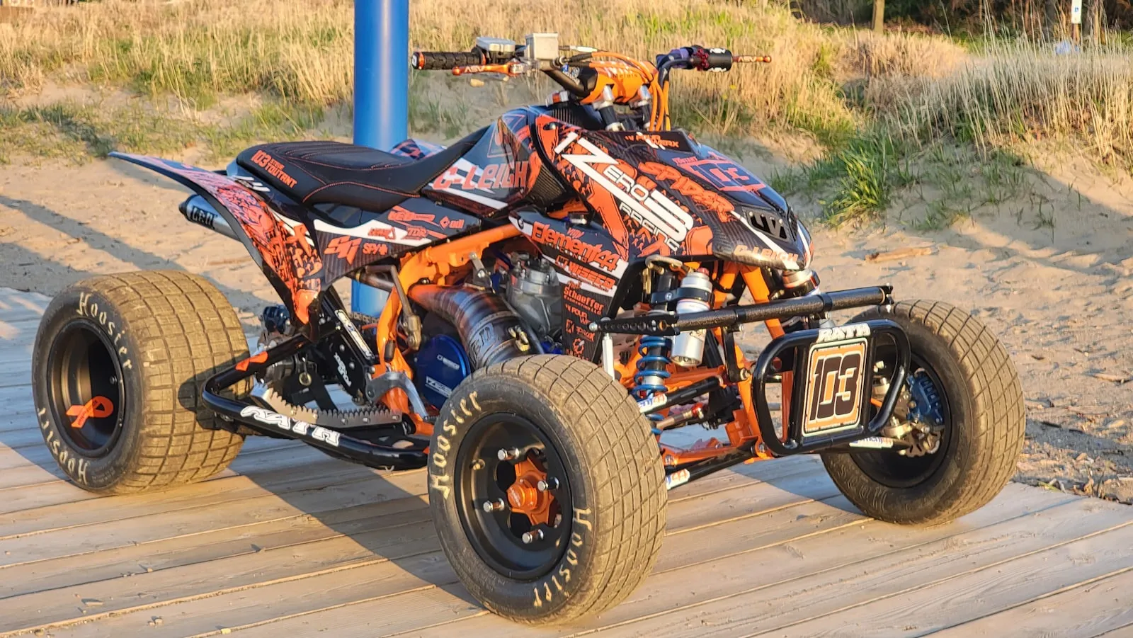 Orange and black ATV parked on a wooden floor — typical ATV install context