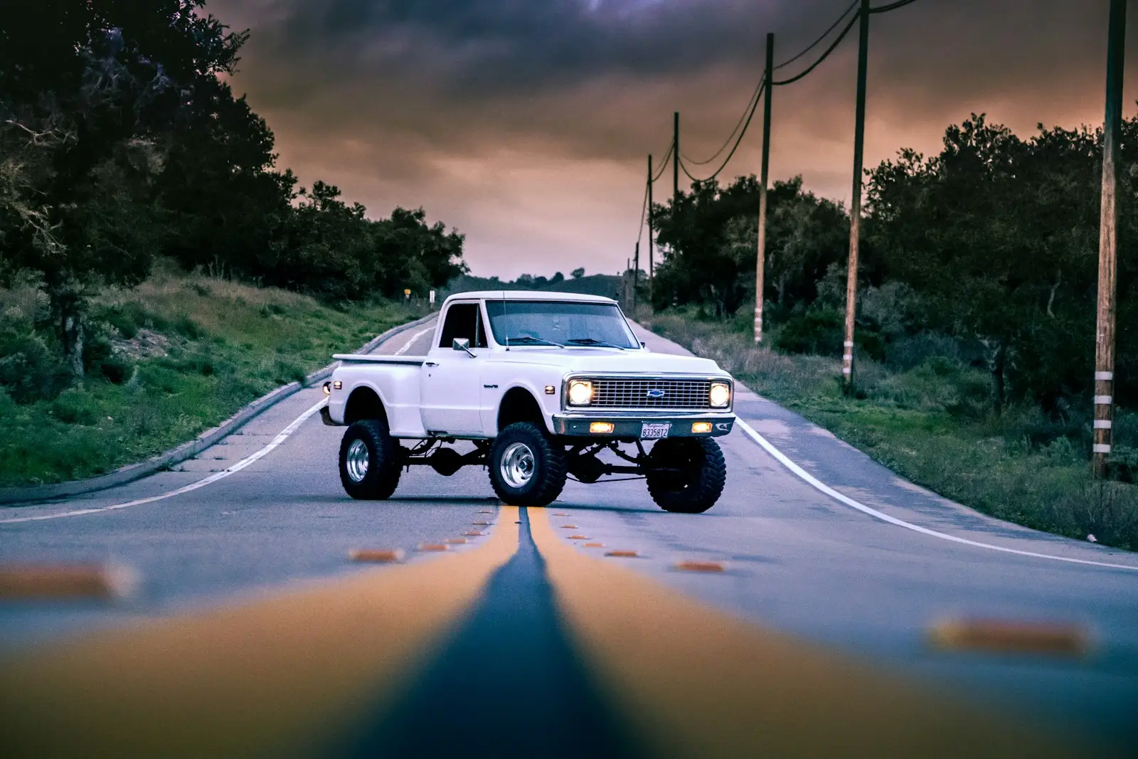 Old lifted chevy on the road.