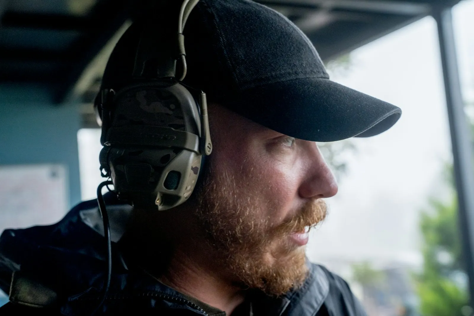 Worker wearing ear muffs — the kind of hearing protection required around horn output above the OSHA pain threshold