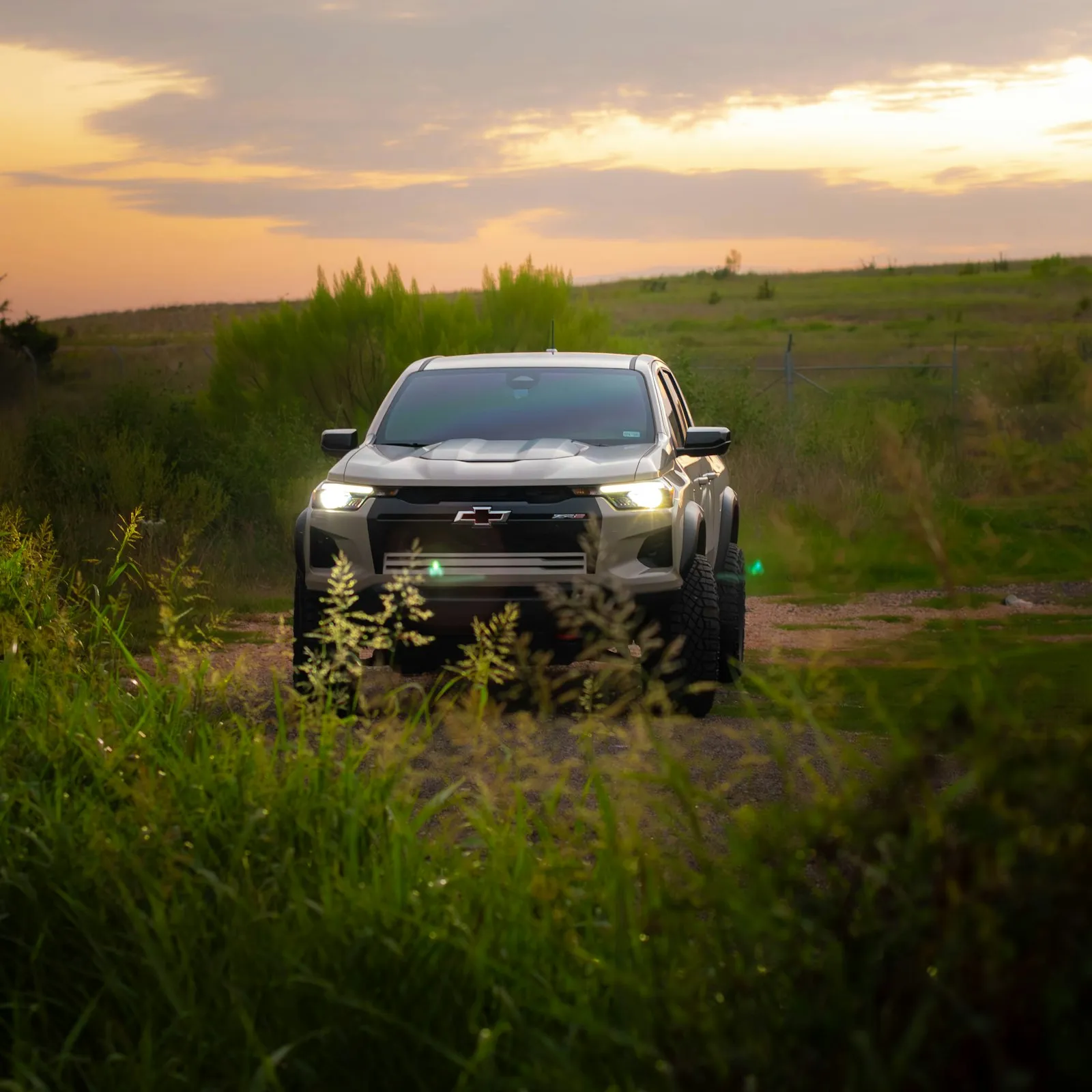 Silver Chevrolet Colorado on a dirt road — mid-size Colorado pickup install context