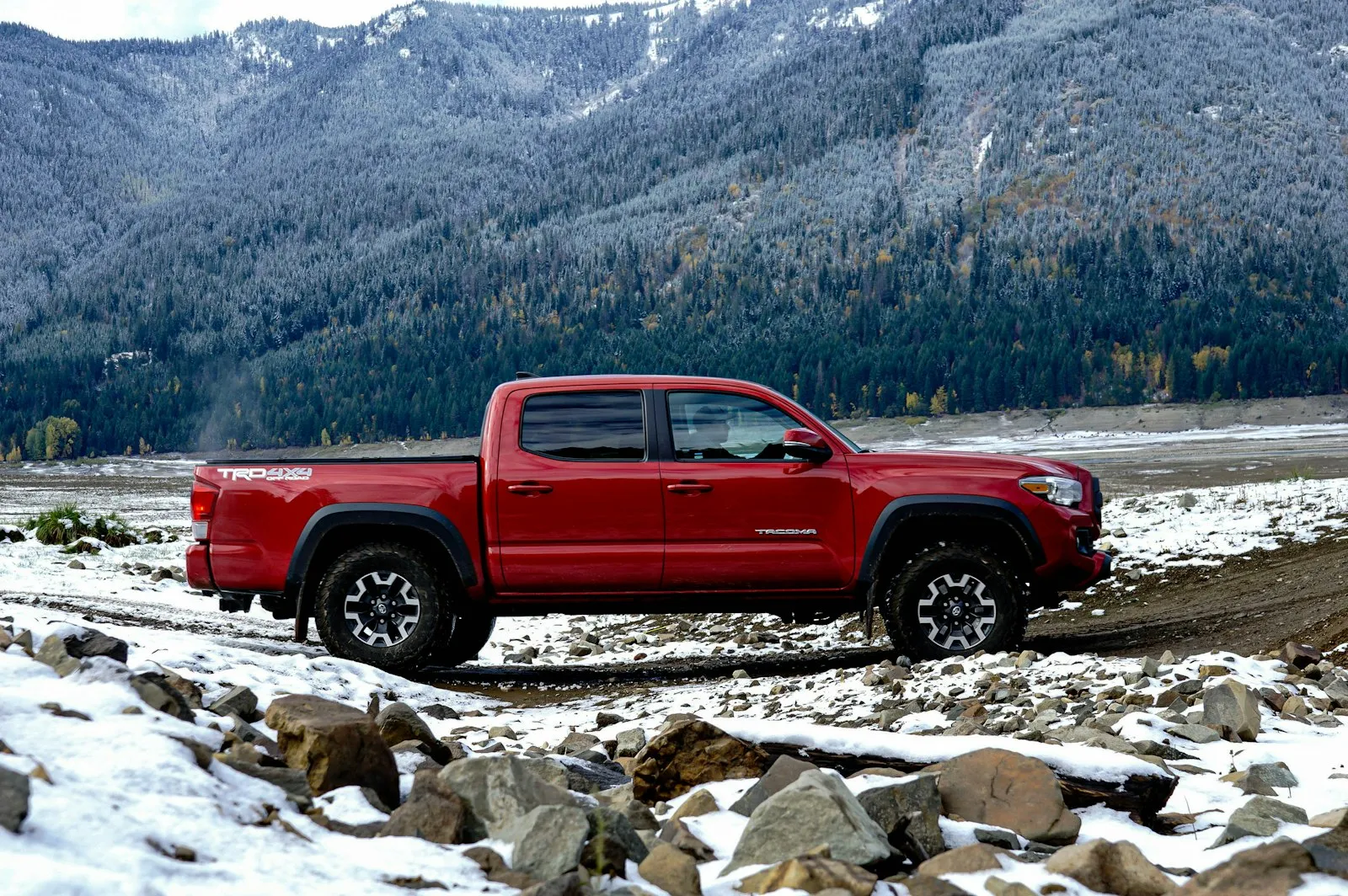 Chevrolet Silverado driving on a wet road — Silverado install context (T1 platform secondary battery tray fits Vixen 0.5-gal kits)