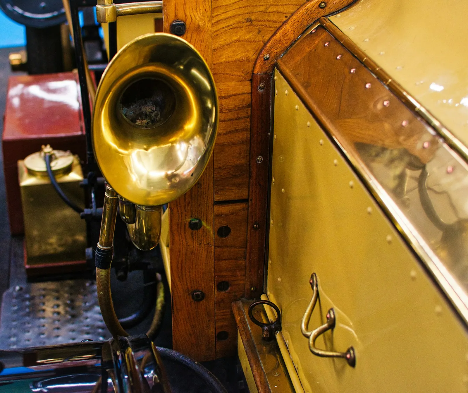 Shiny brass horn on a vintage vehicle with wood trim