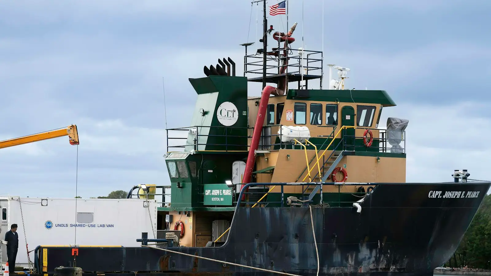 This image captures the Capt. Joseph E. Pierce, a working vessel docked at Woods Hole, Massachusetts, likely engaged in marine research. The "UNOLS Shared-Use L