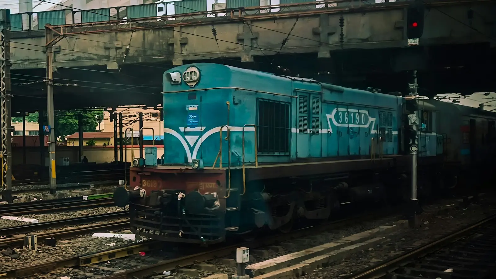 Indian WDM-3A Blue Diesel Locomotive Under Urban Overpass