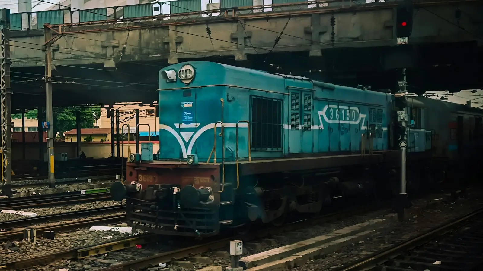 Indian WDM-3A Blue Diesel Locomotive Under Urban Overpass