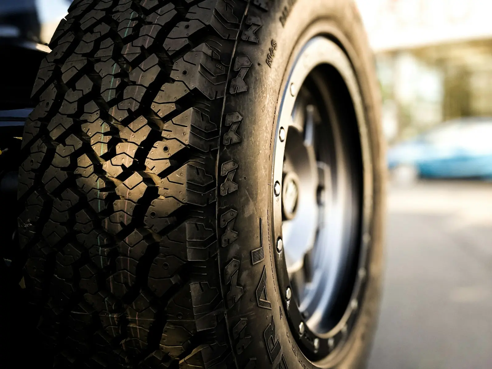 A brand new custom Jeep Tire and rim in a used wrangler in sunlight and shadow.