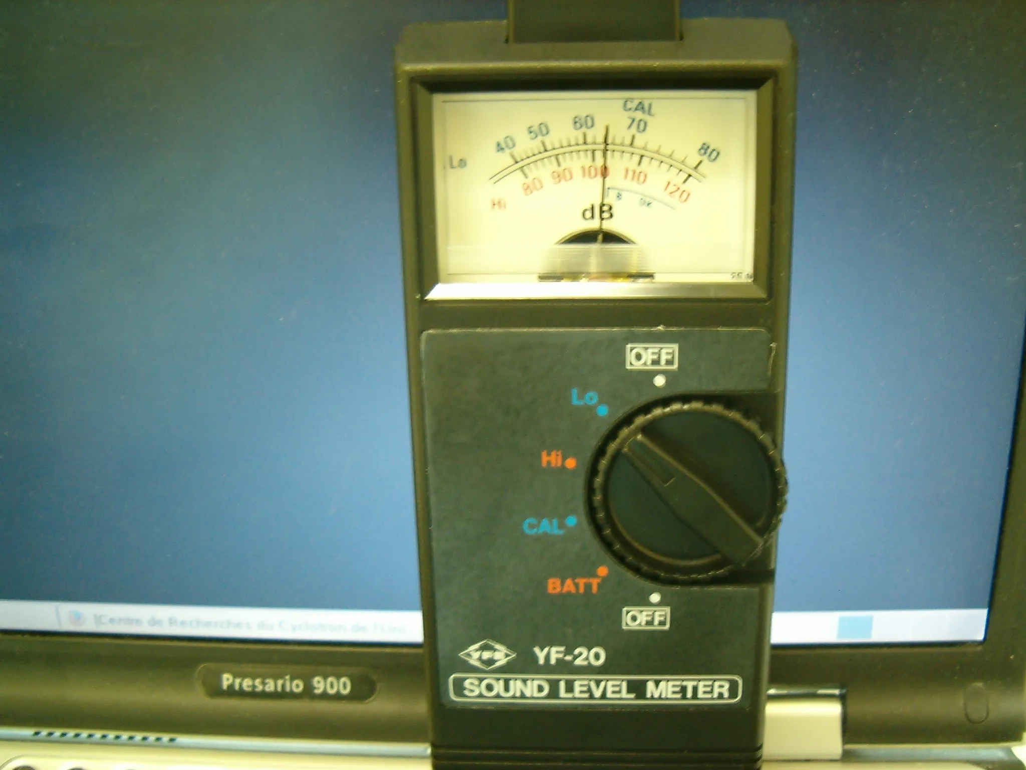 Handheld digital sound level meter displaying a decibel reading