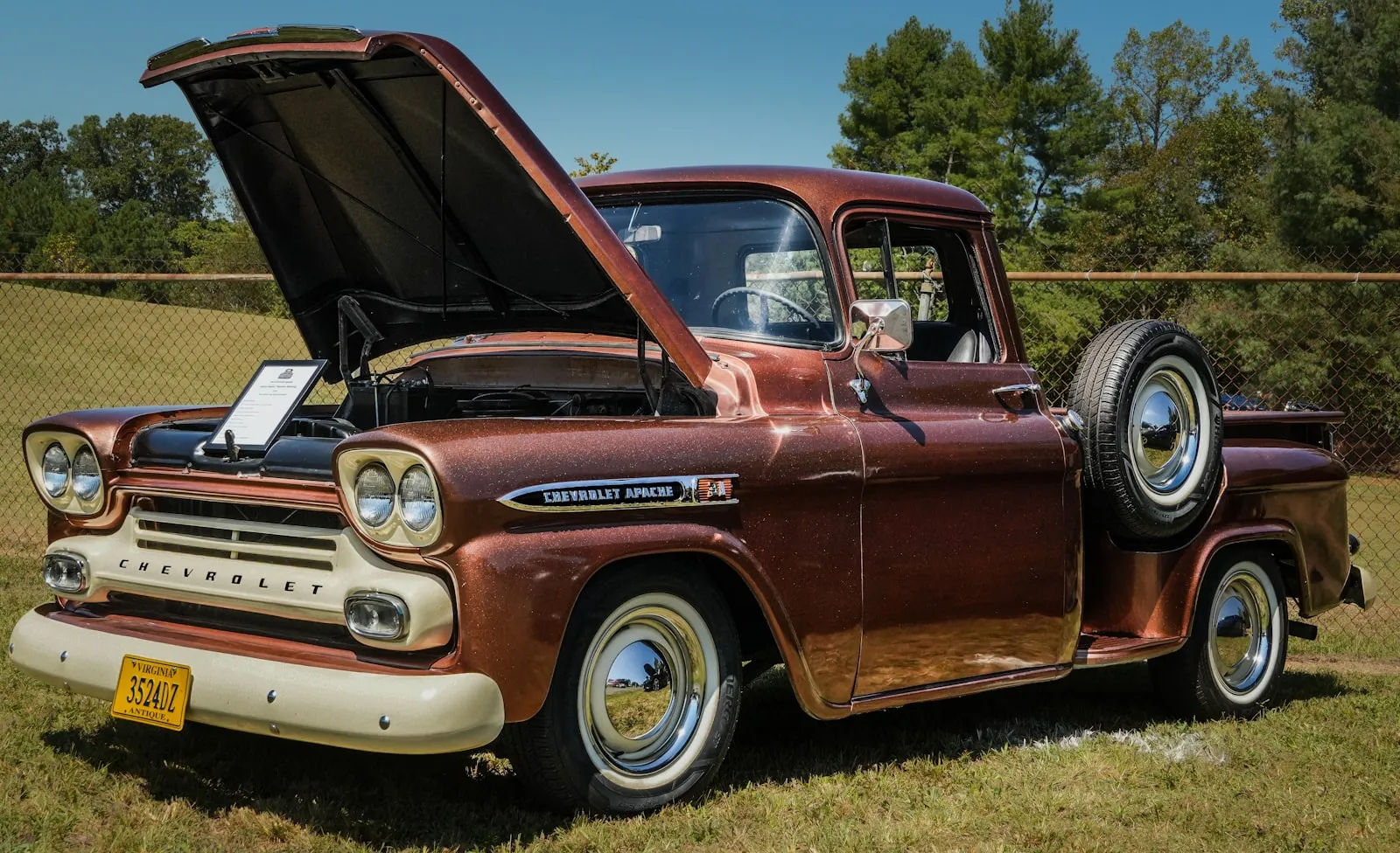 Vintage Chevrolet pickup truck with the hood open in a mechanic shop — the install context every train horn DIY scenario builds on