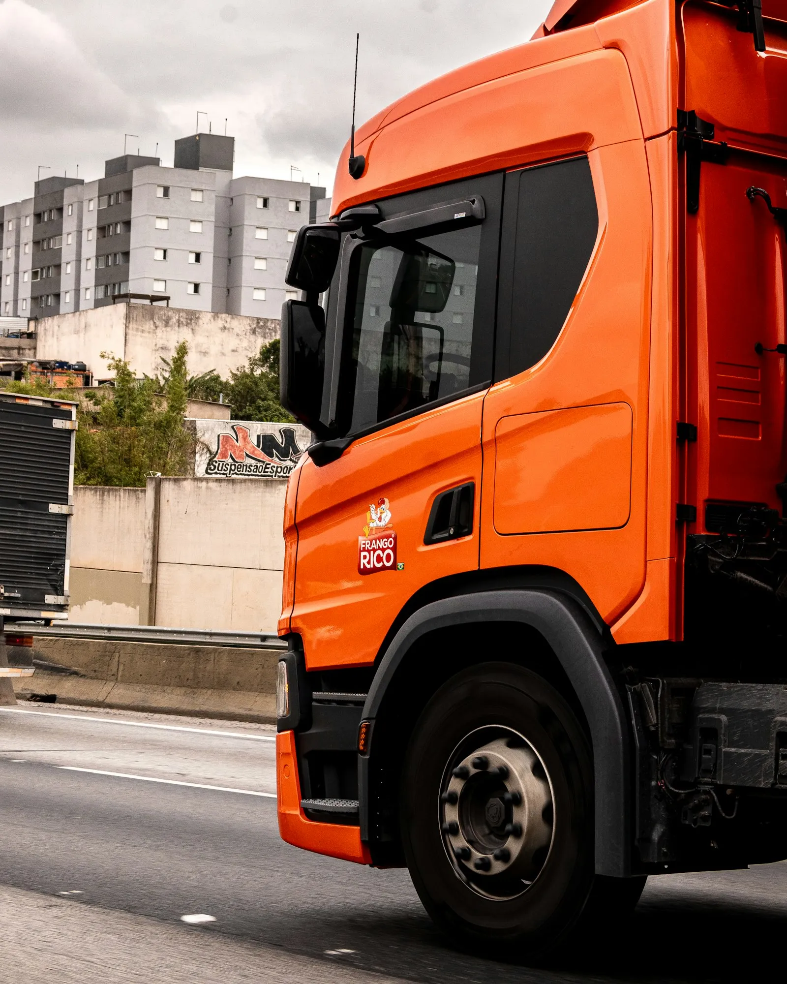 Orange truck on the highway — the heavy-duty install context that the Kleinn HK9 premium kit targets
