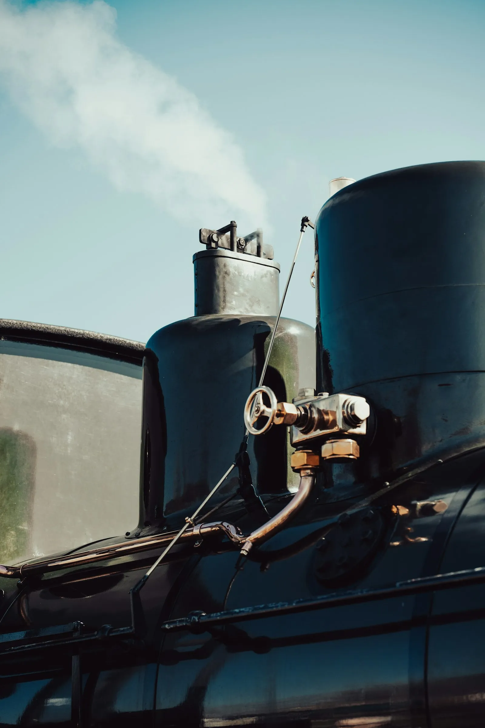 Steam billowing from a vintage locomotive — the steam-era whistle that the modern chord horn replaced