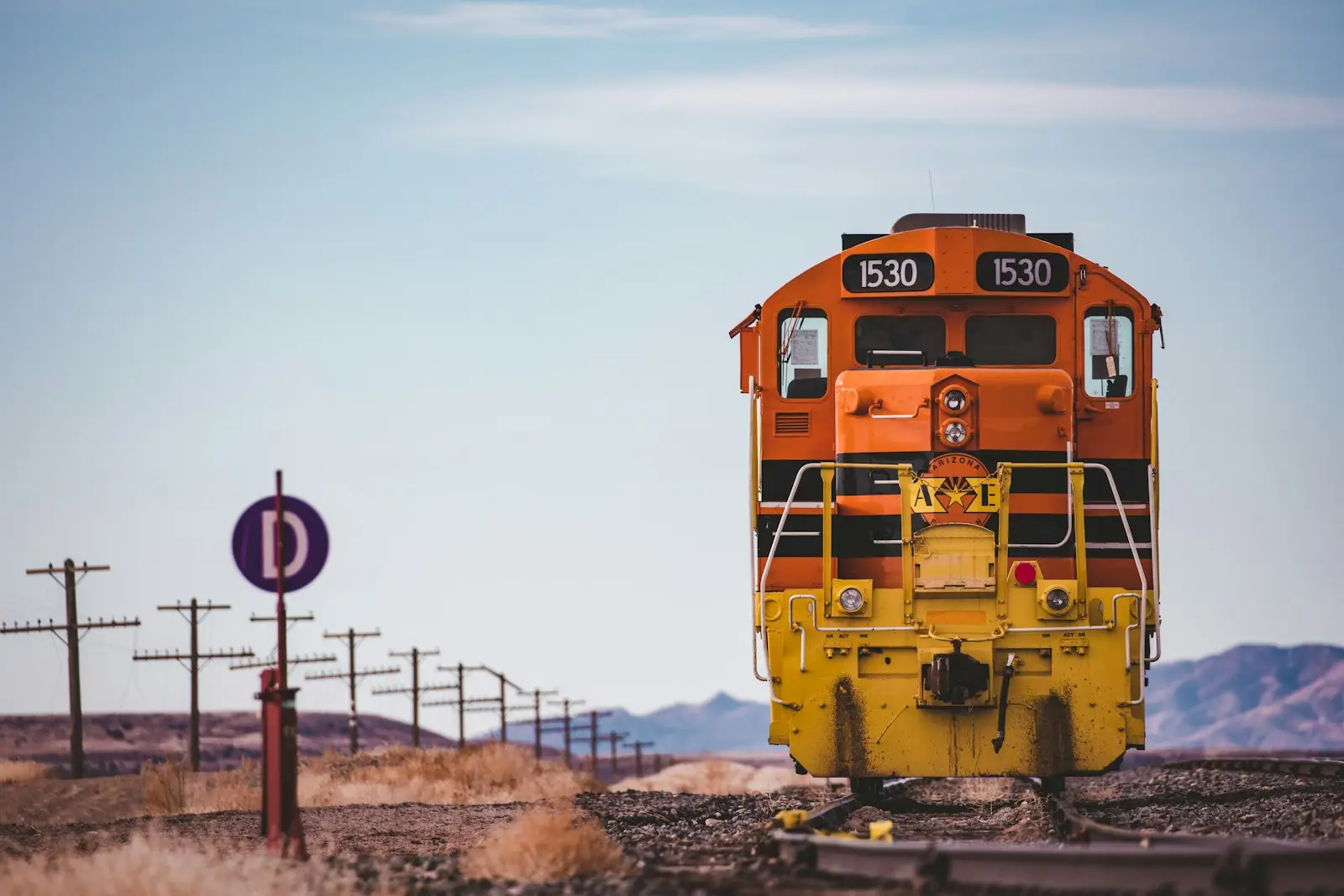 Yellow and black train on rail tracks during daytime