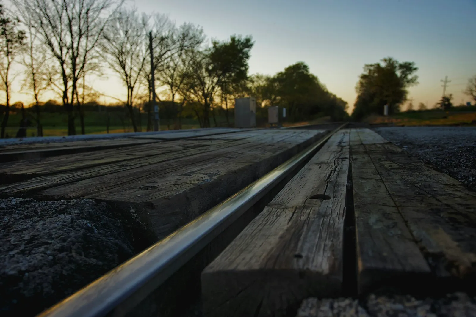 A wooden bench sitting on top of a road