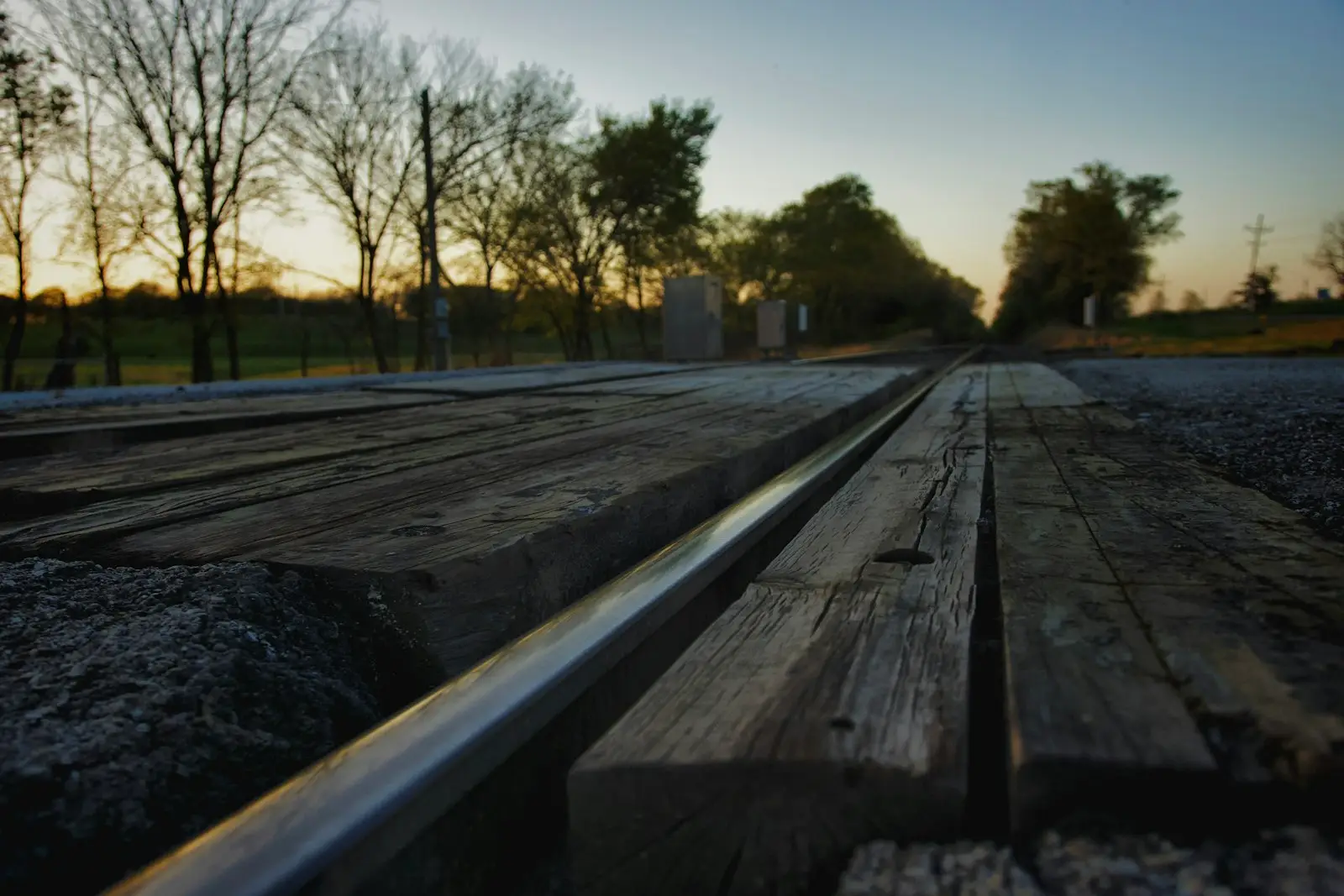 A wooden bench sitting on top of a road
