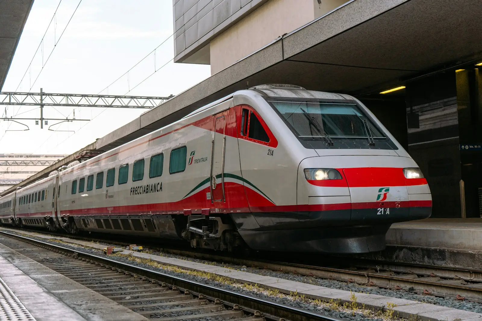 A modern red and white train at a station