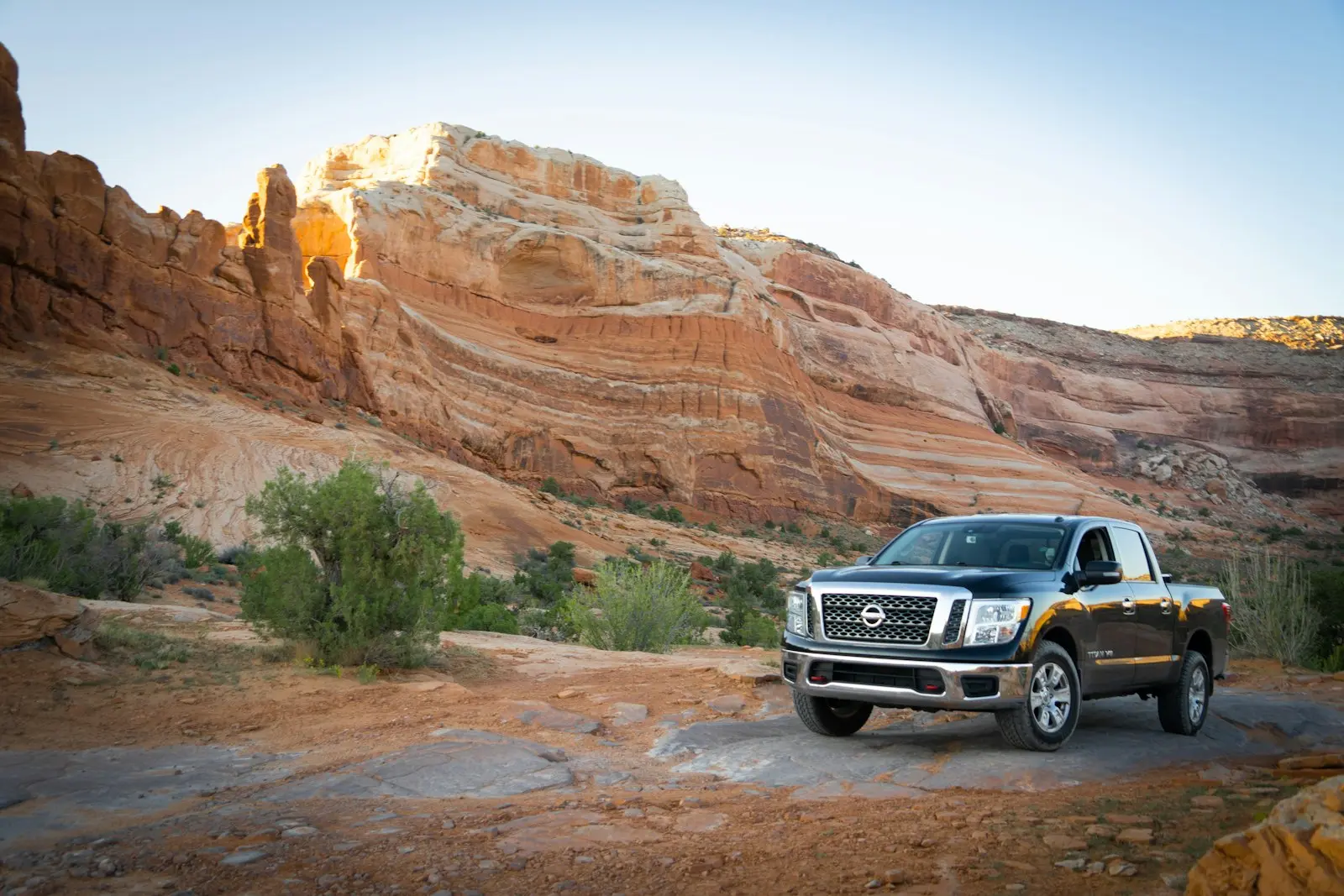 Black Nissan Titan in front of mountains — Titan full-size install context