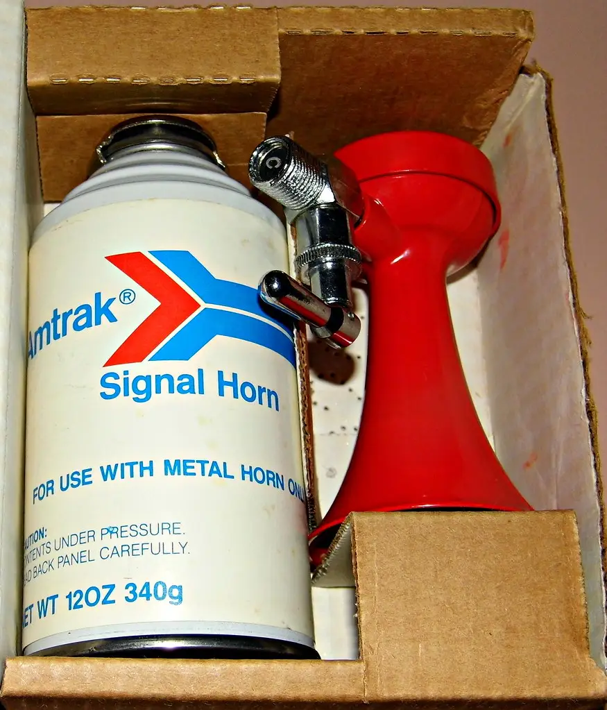 Vintage handheld railroad signal air horn with a flared metal trumpet