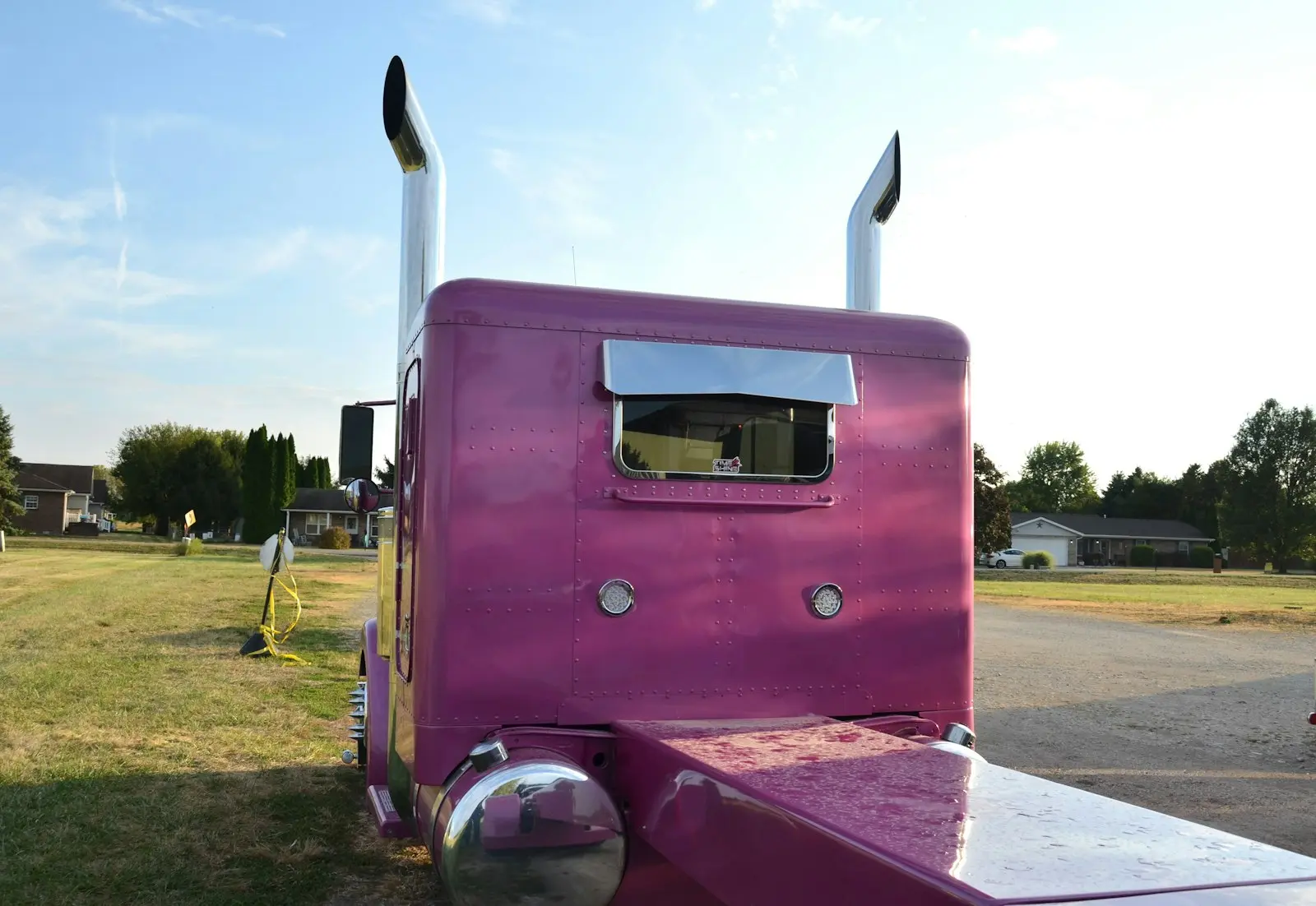 Pink semi-truck with chrome exhaust pipes — generic Class 8 semi-truck install context