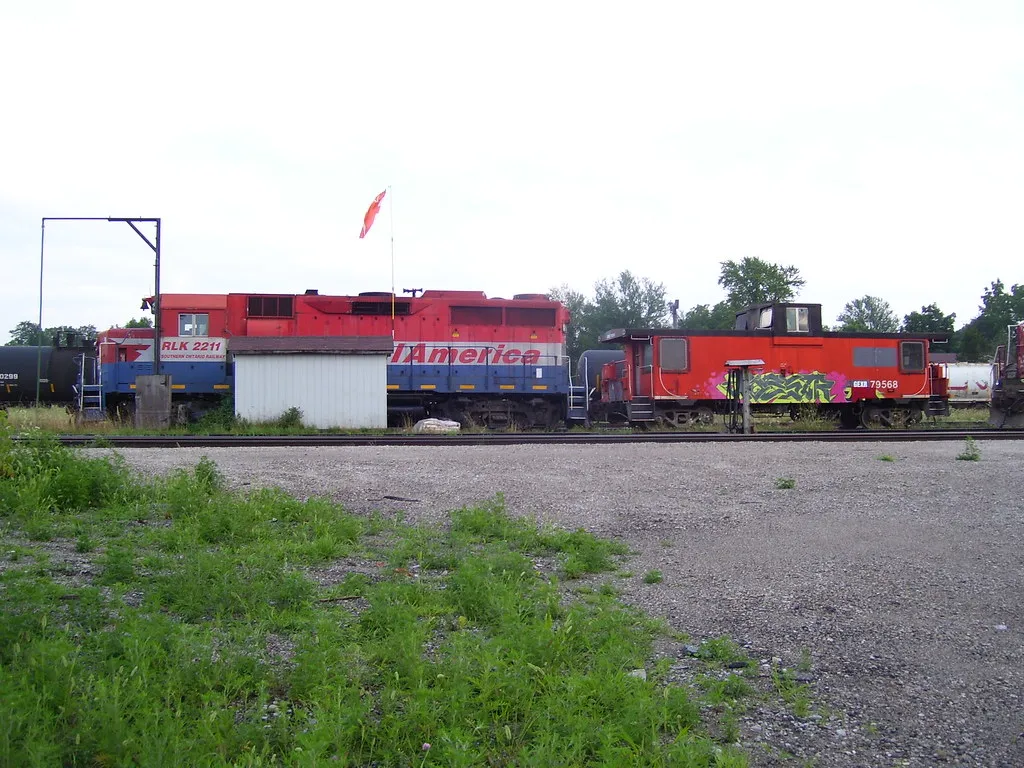 Diesel locomotive and caboose in a railway yard