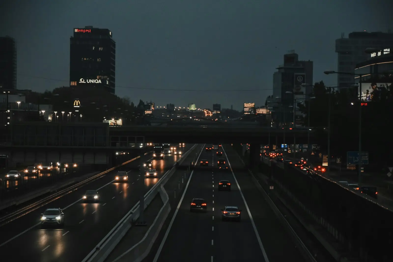 A freeway with cars on it and buildings in the background