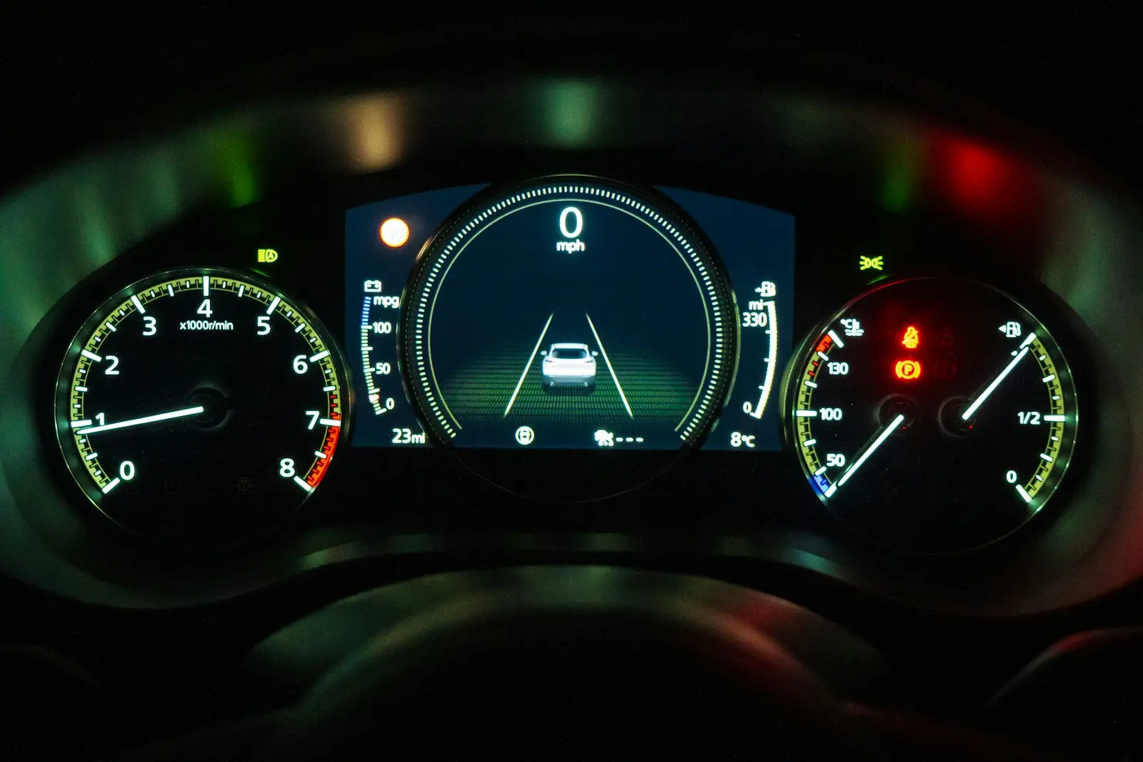 An illuminated car dashboard.