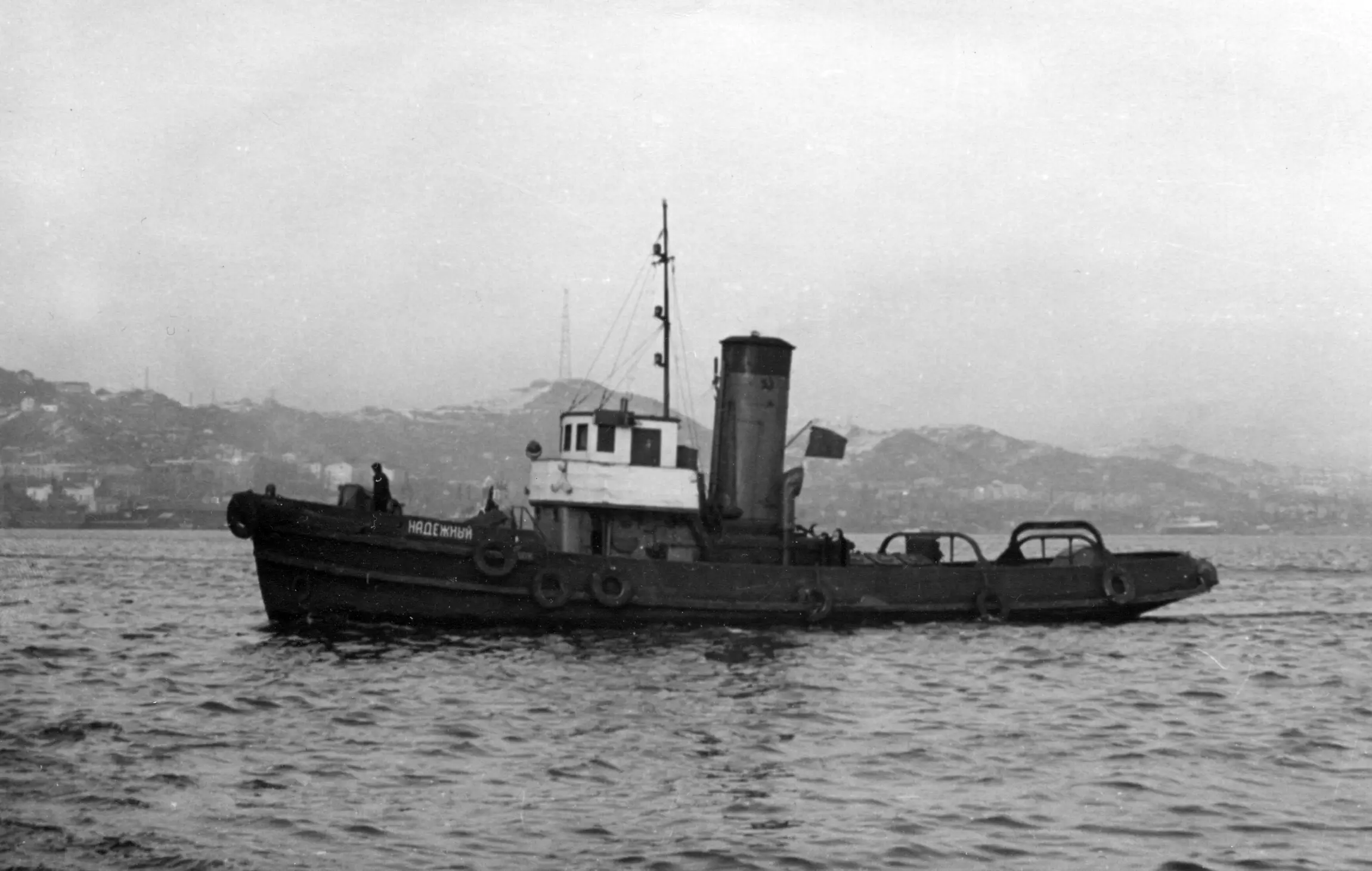 Tugboat underway on open water, the kind of working vessel that relies on a powerful air horn