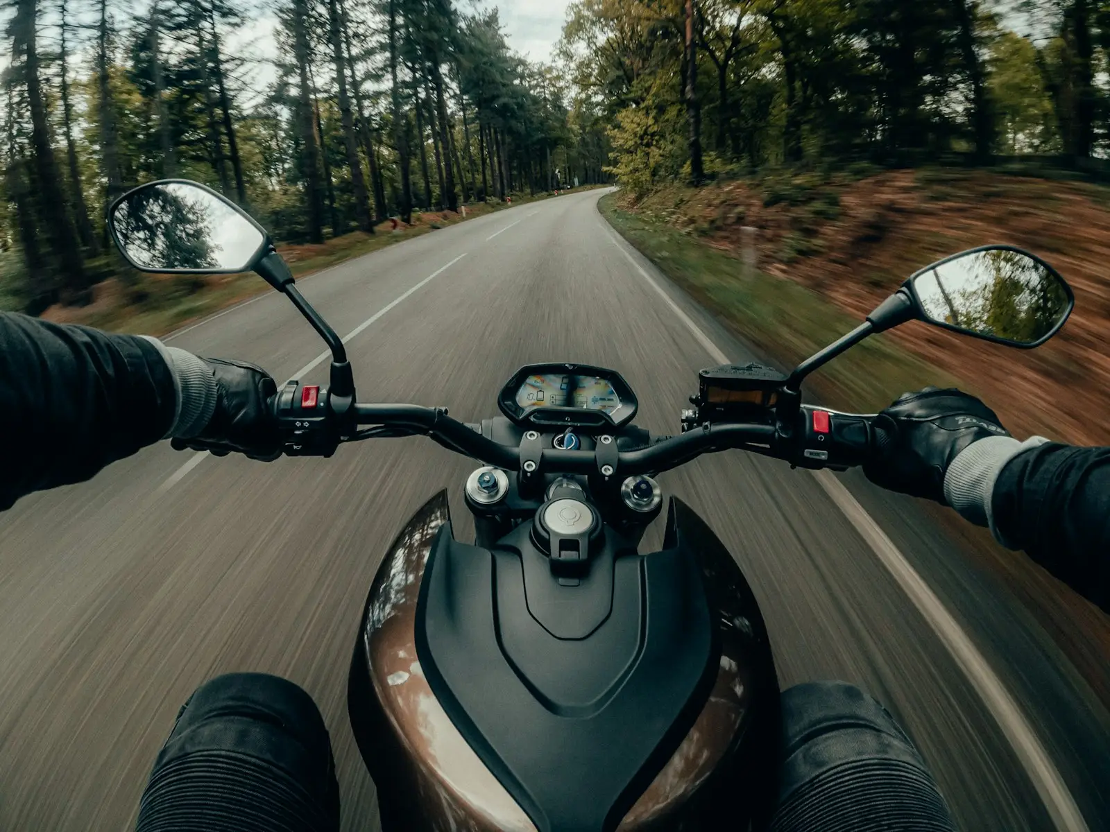 Black and gray motorcycle on road during daytime