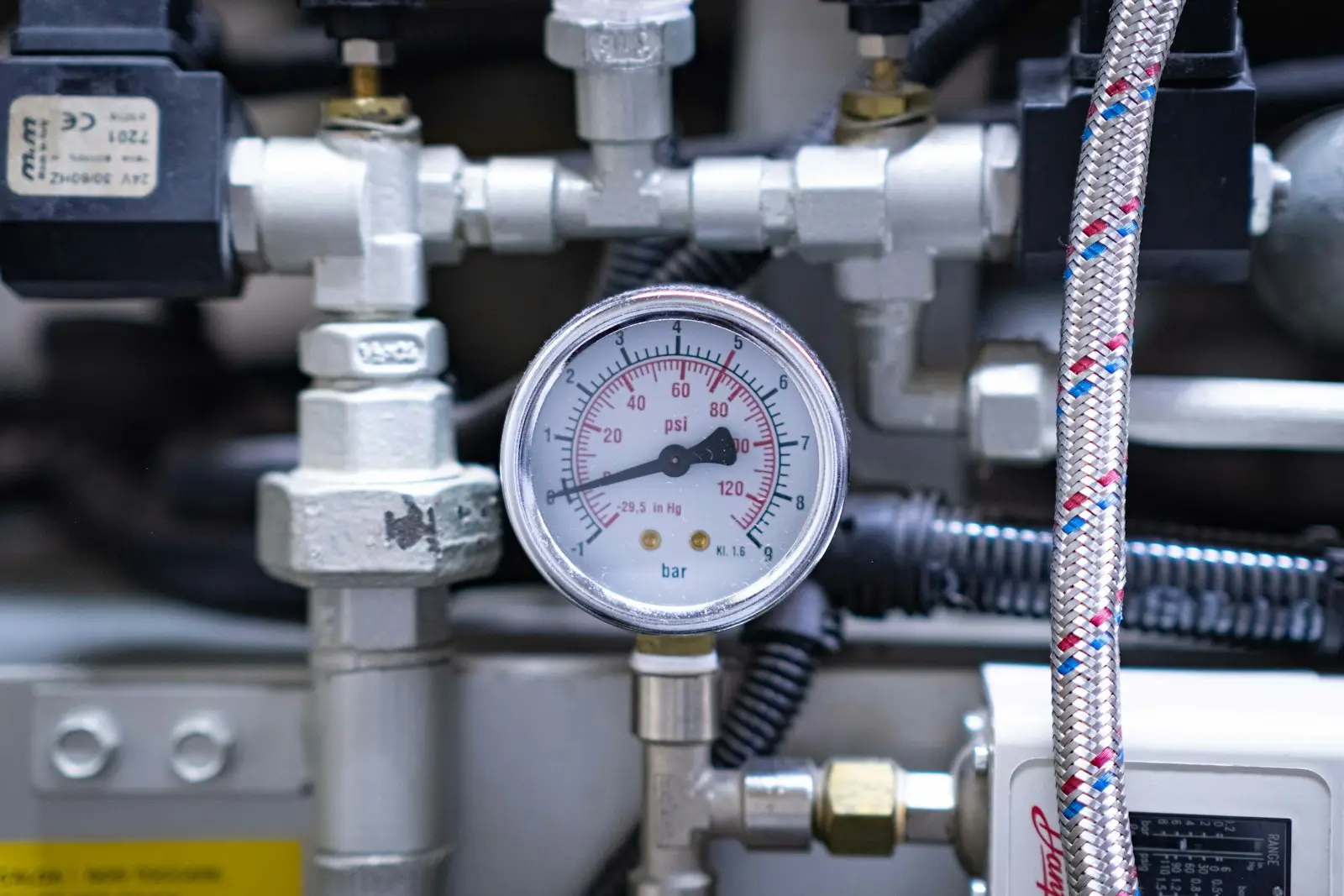 A close up of a pressure gauge on a machine
