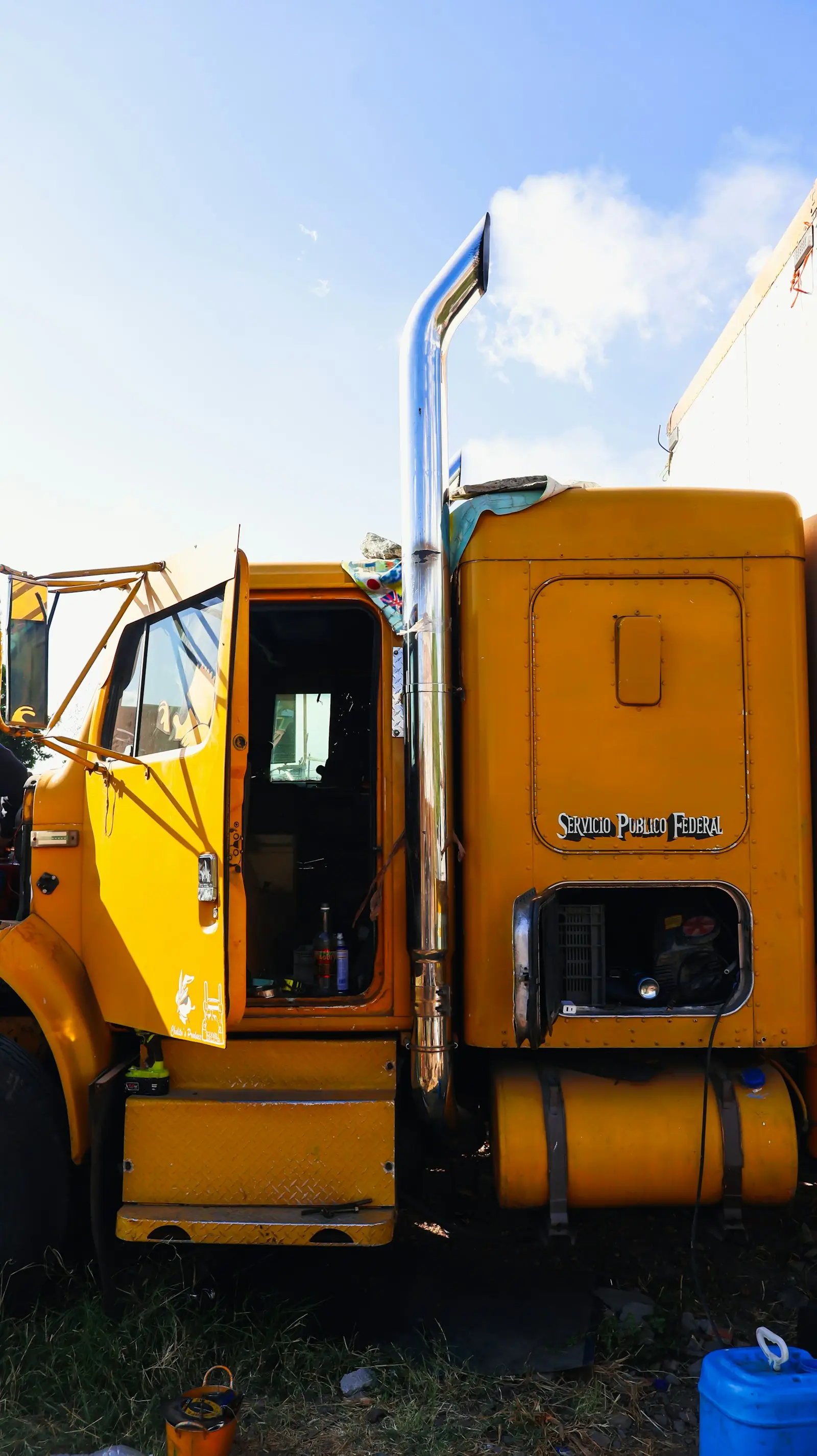 Yellow semi-truck with exhaust smoke — Class 8 cab where stereo split-mount kits like the Shocker S6 fit