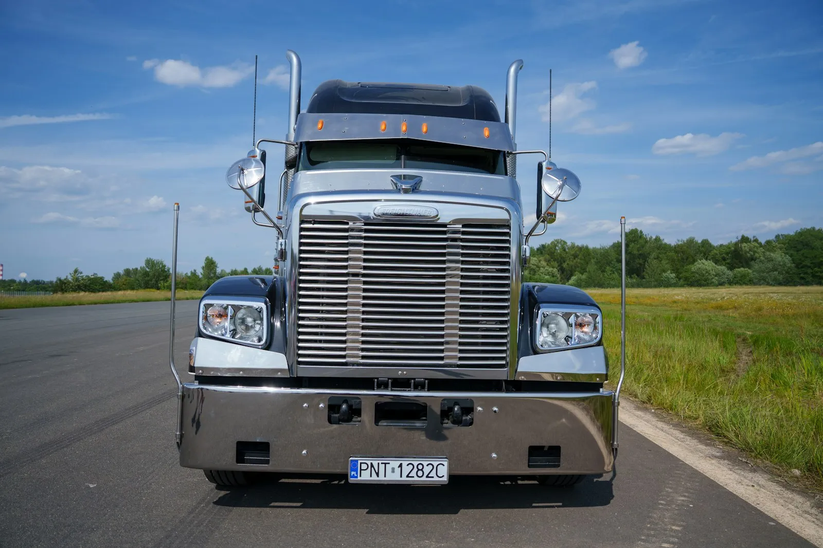 Chrome truck mirror with orange turn signal — under-hood compact install context for Vixen 0.5-gal kits