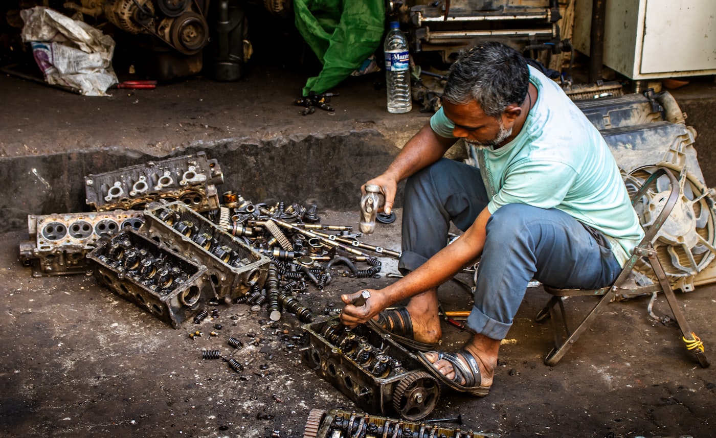 Mechanic on a car engine — compact pickup install scenario for Wolo's OEM-heritage kits